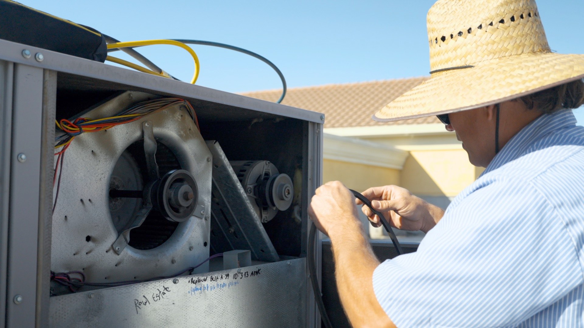 NALK technician performing residential AC repair in Fresno home