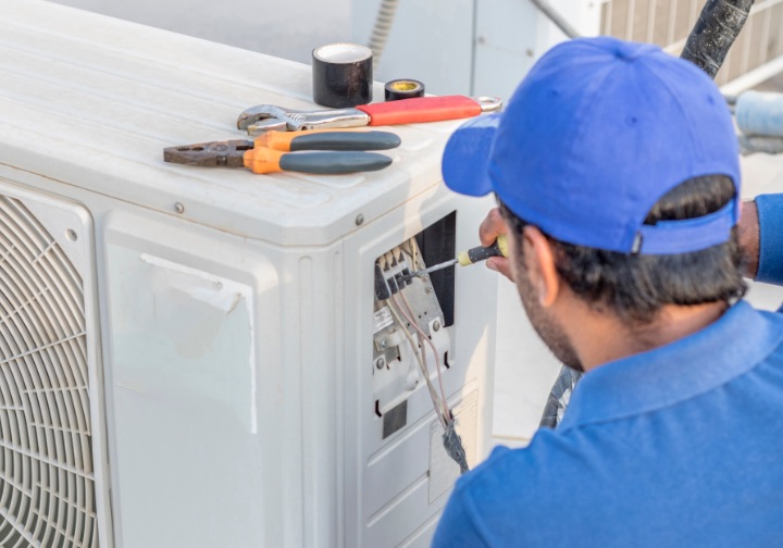 NALK Cooling & Heating technician performing a commercial HVAC repair.