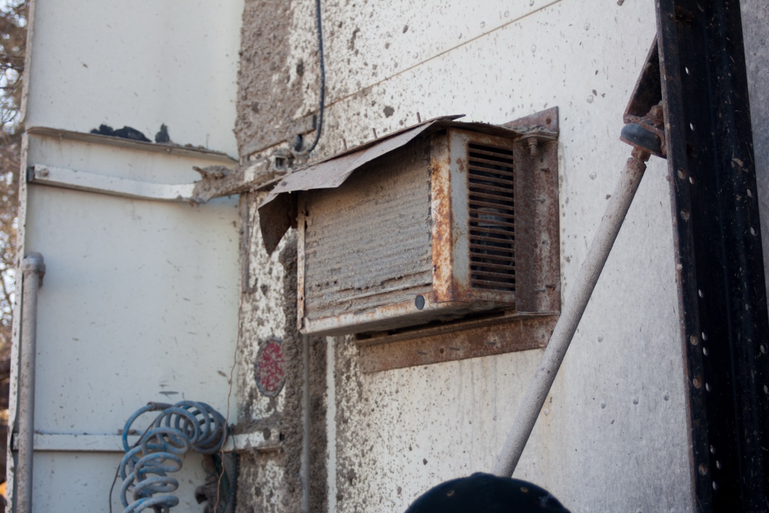 Technician inspecting an aging HVAC system in a Fresno home to determine if replacement is needed
